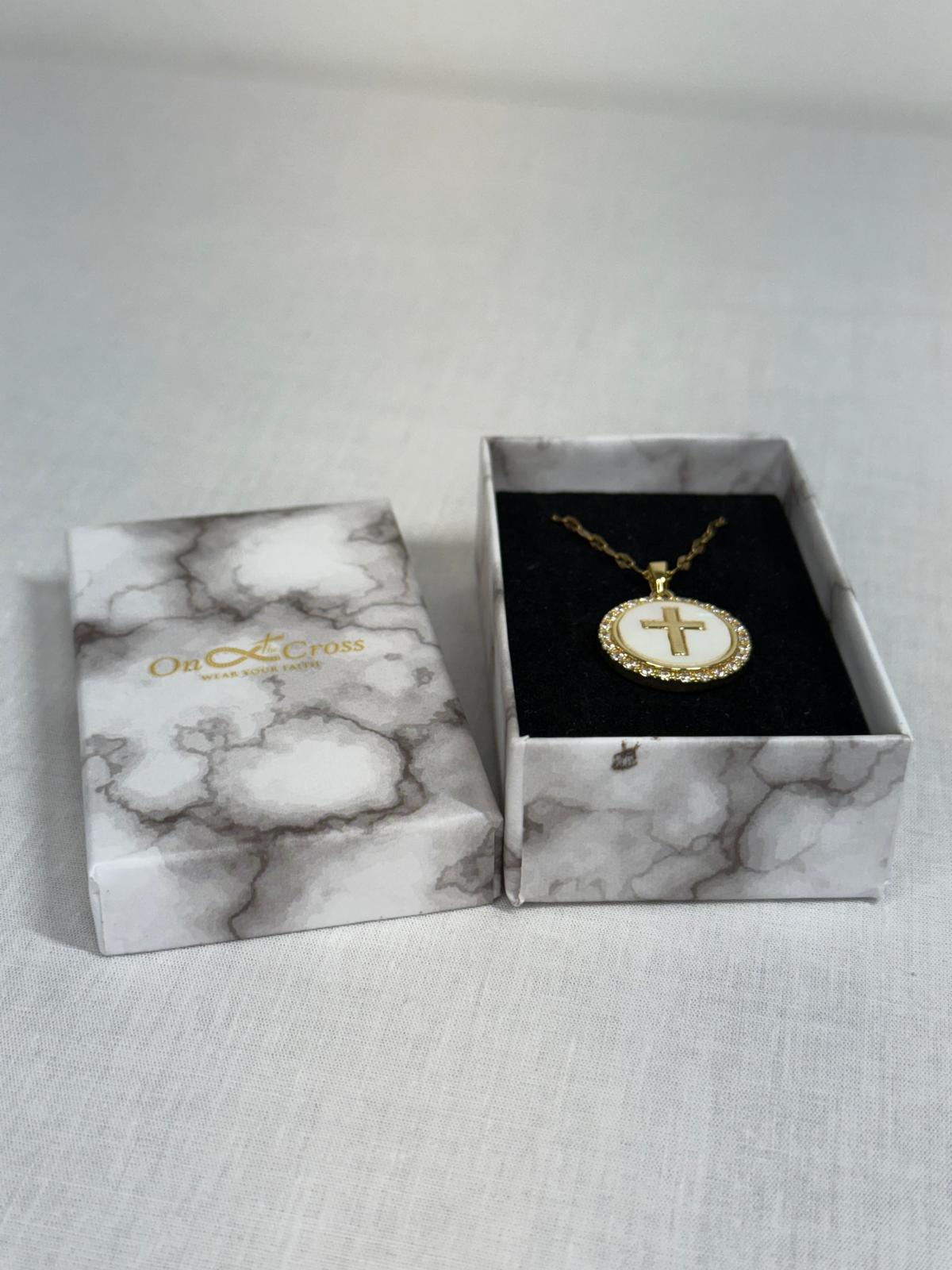 Woman’s Gold plated round cross pendant.