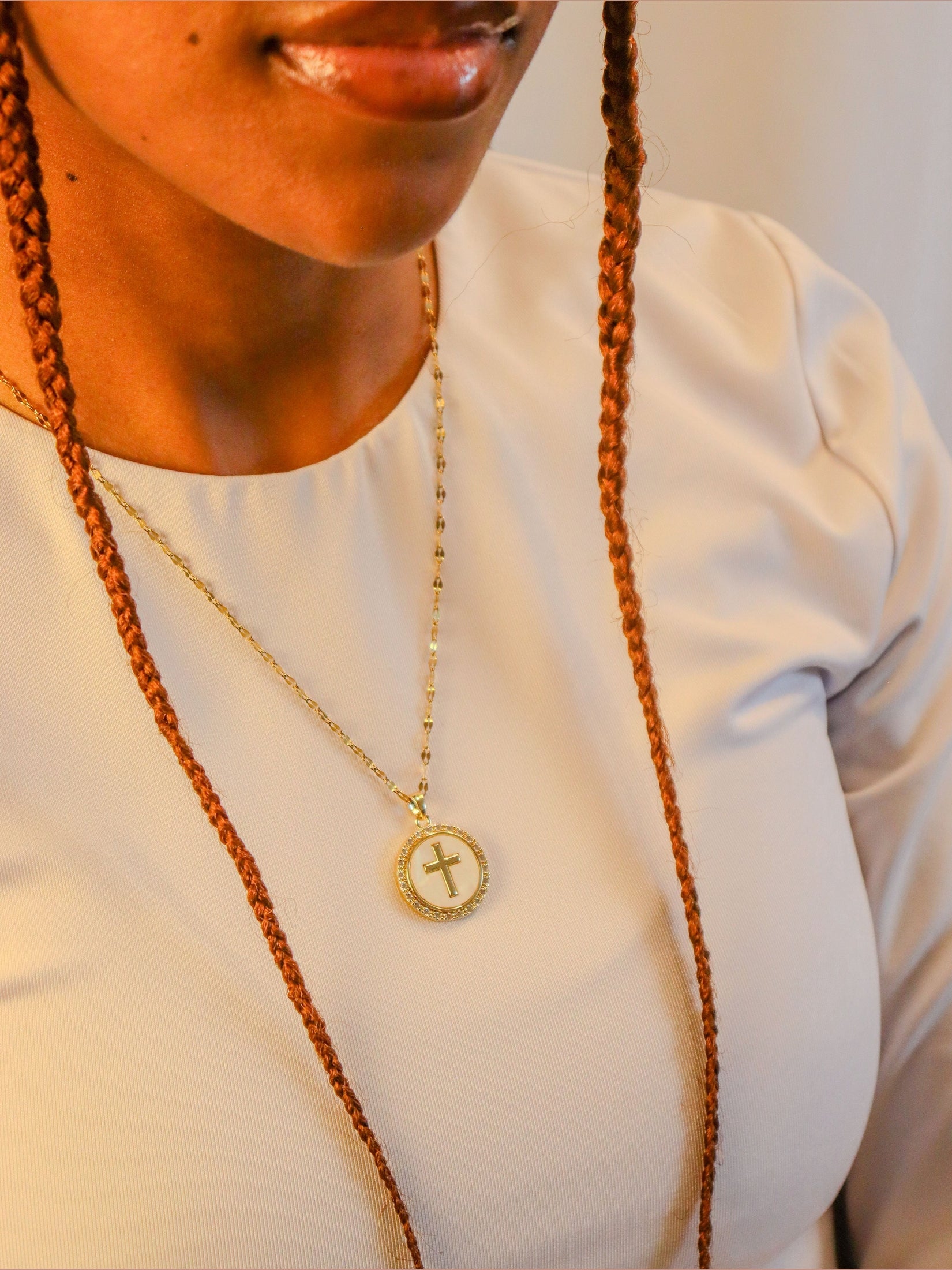Woman’s Gold plated round cross pendant.
